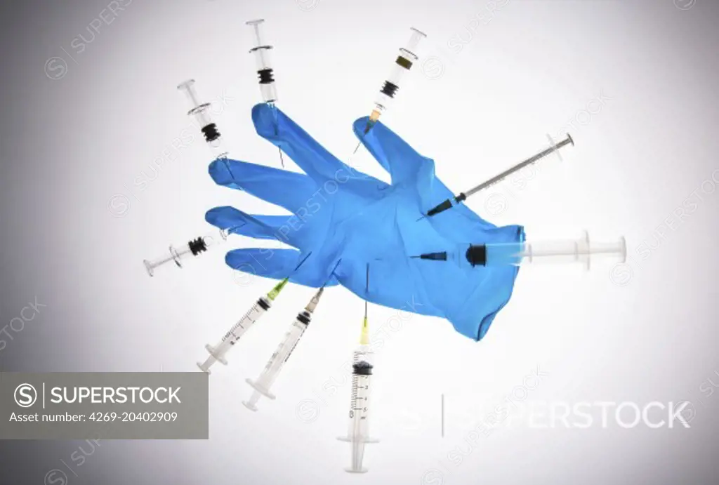 Glove and syringes. Conceptual image about the risk of contamination.