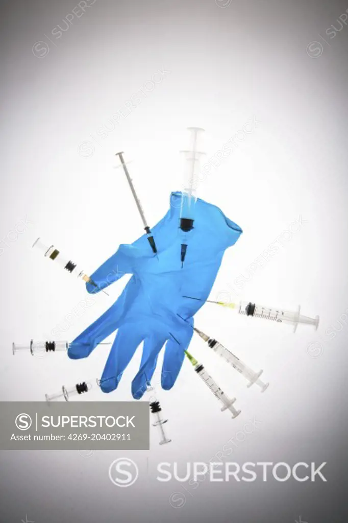 Glove and syringes. Conceptual image about the risk of contamination.