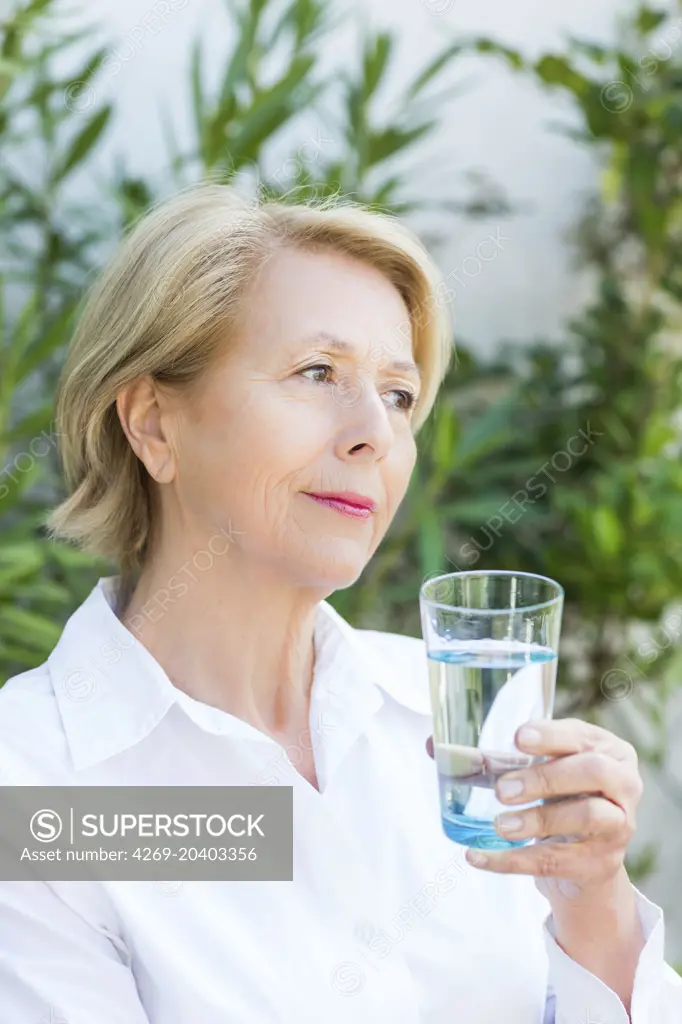 Woman drinking of glass of water.