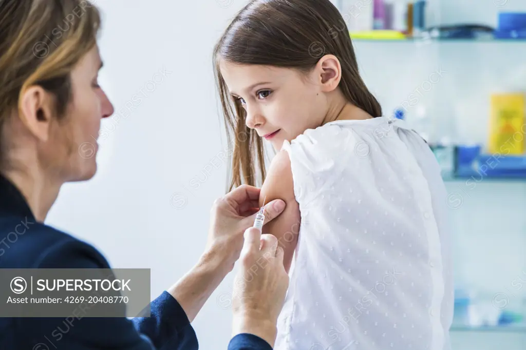 7 years old girl receiving a vaccination.