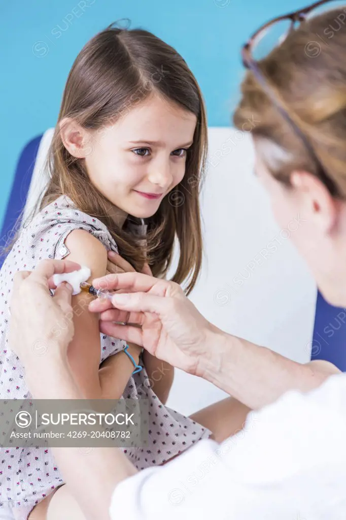 7 years old girl receiving a vaccination.