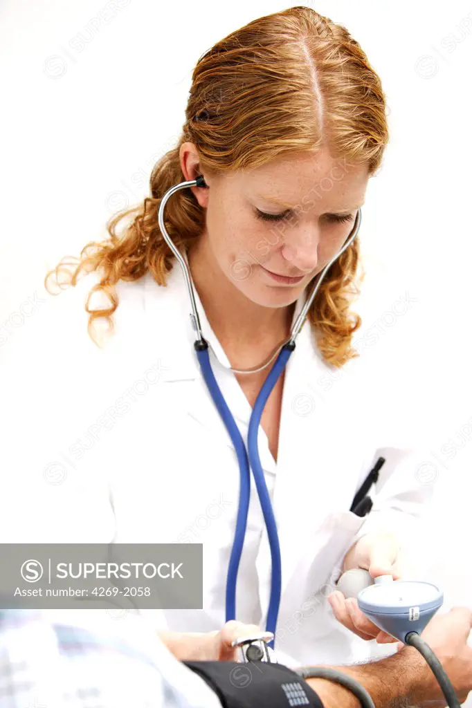 Female doctor checking the blood pressure of a patient.