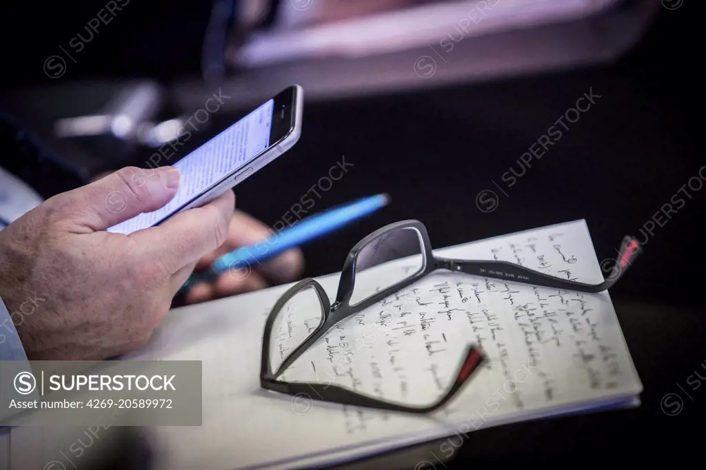 Man using his cell phone during a meeting.