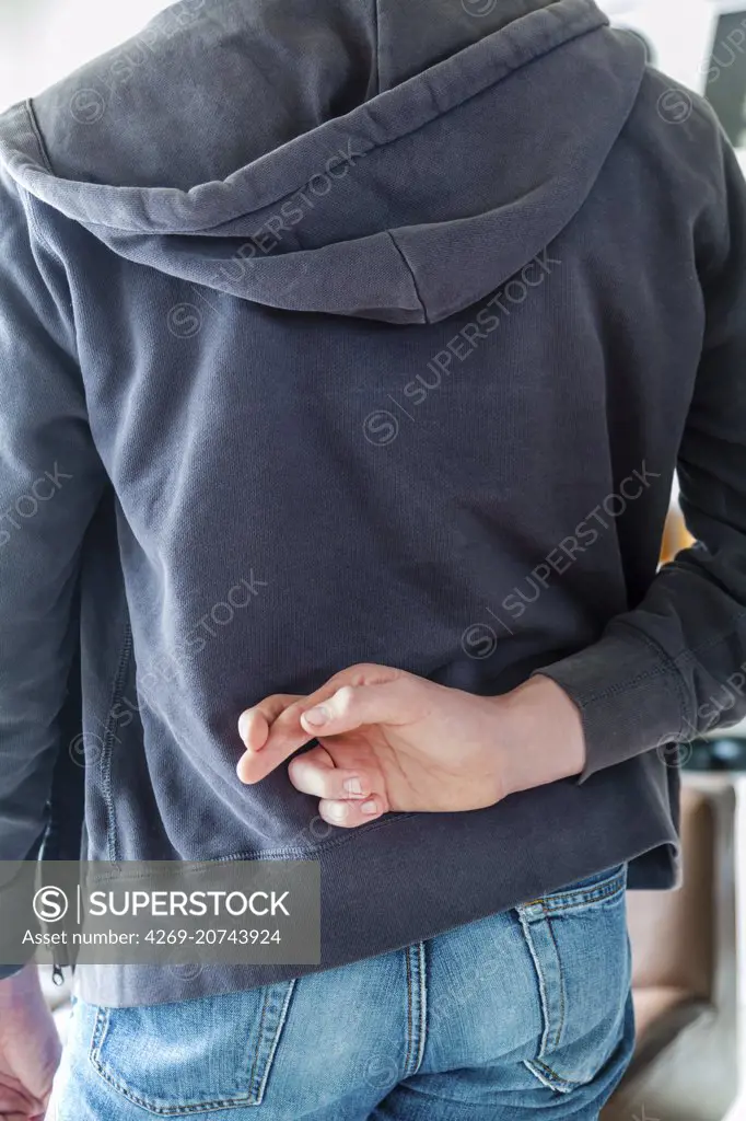 Teenager keeping his fingers.