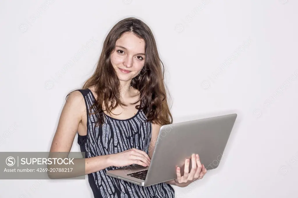 Teenage girl using a laptop.