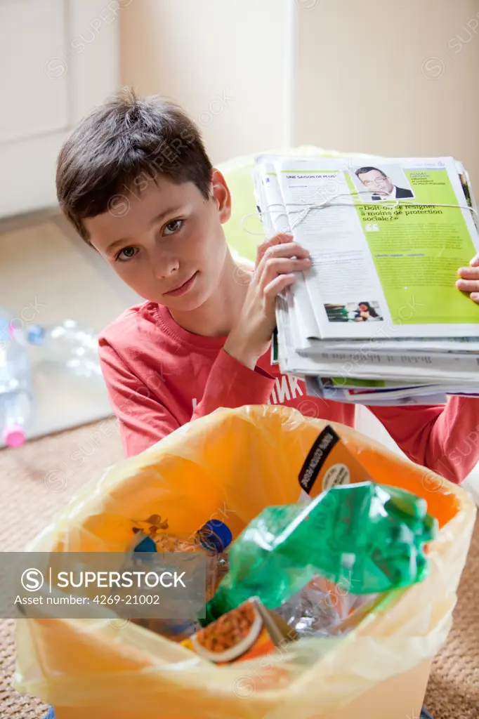 Boy sorting recycled wastes.