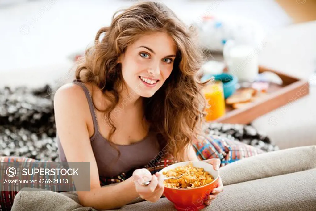 Woman eating cereals.