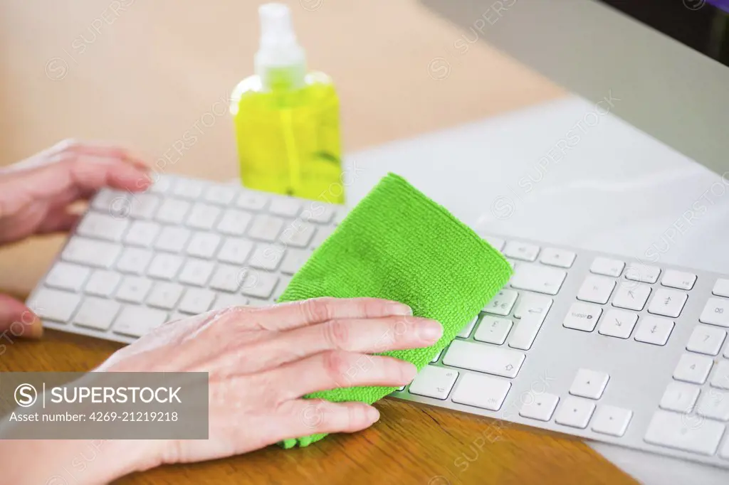 Woman cleaning her computer.