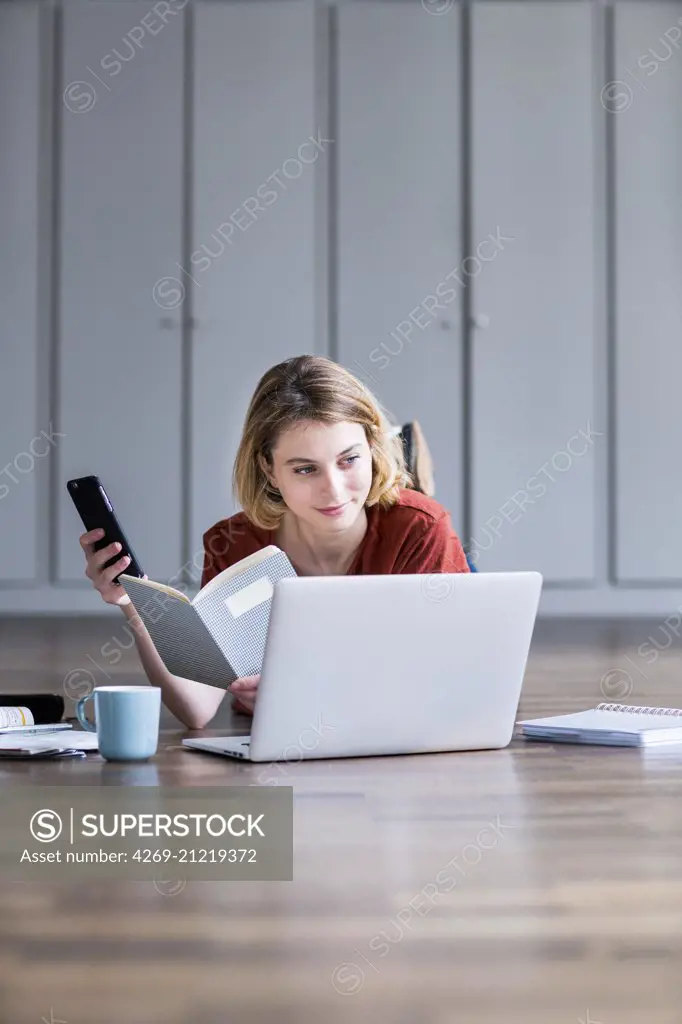 Woman using a laptop and a smartphone.