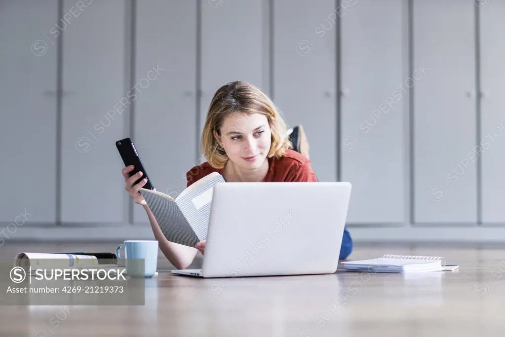 Woman using a laptop and a smartphone.