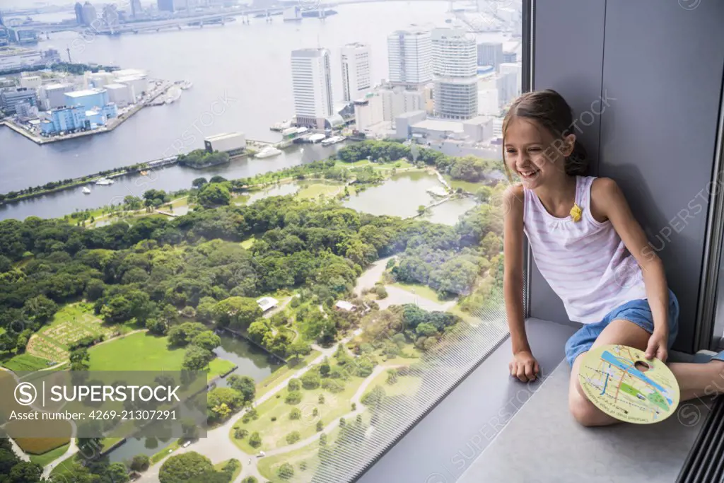 8 year old girl looking at Tokyo Bay, Japan.