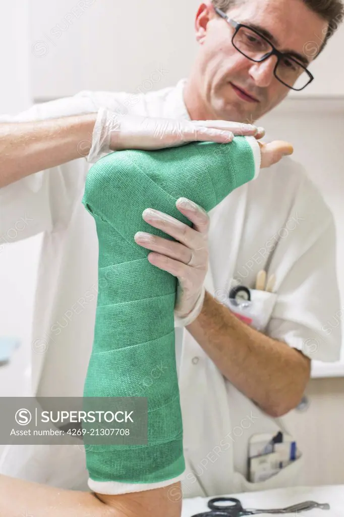 Doctor placing a plaster , emergency department of a private hospital .