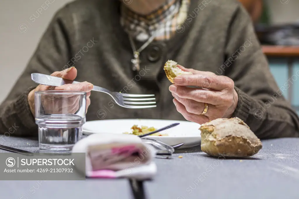 Elderly person eating.