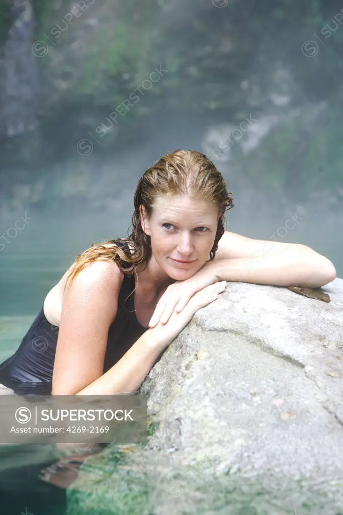 Woman bathing in geothermal hot springs.
