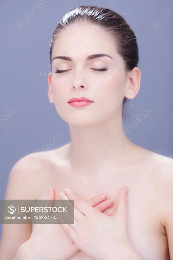 Woman with hand on her chest.