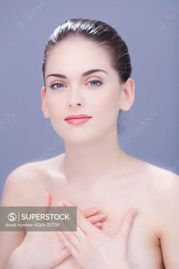 Woman with hand on her chest.