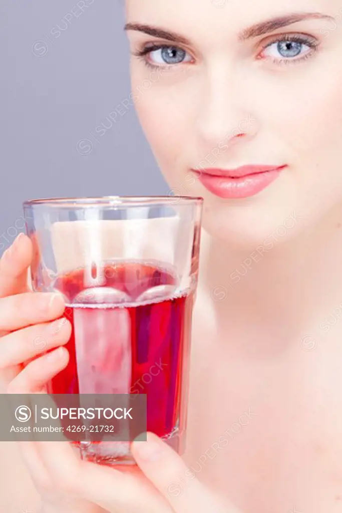 Woman drinking fruit juice.