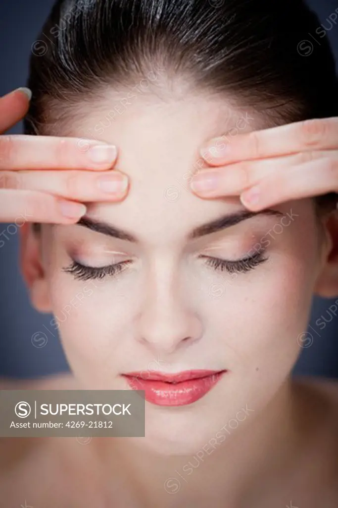 Woman massaging forehead.