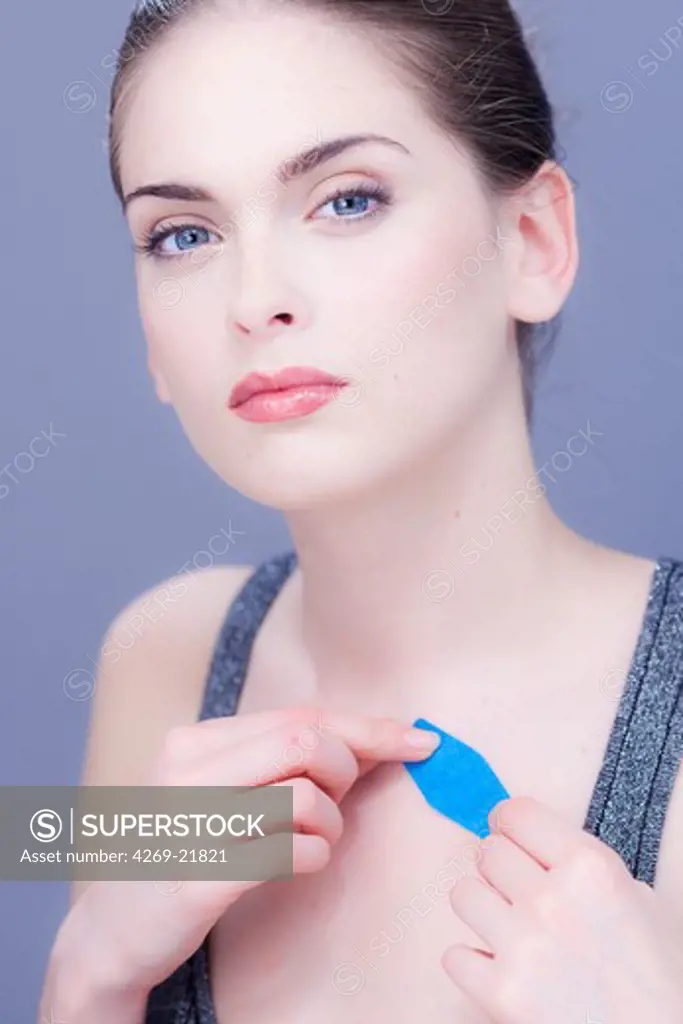 Woman putting a band-aid.