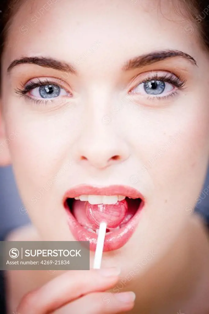 Woman eating a lollipop.