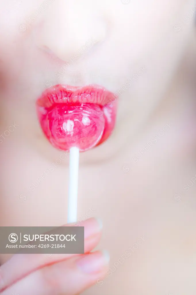Woman eating a lollipop.