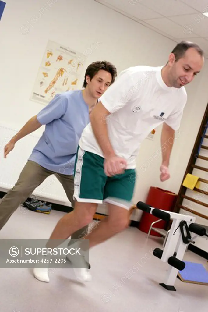Patient suffering from a knee and Achilles tendinitis practising muscular tone (proprioception) and balance rehabilitation exercises with a physiotherapist.