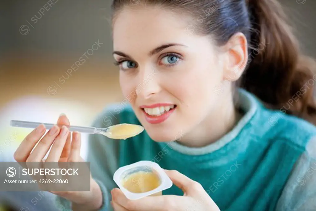 Woman eating compote.