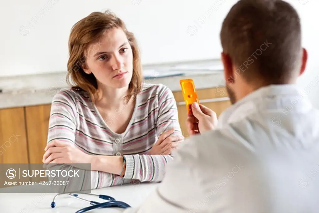 A doctor explains a teenager the use of the morning-after pill (emergency contraceptive pill).