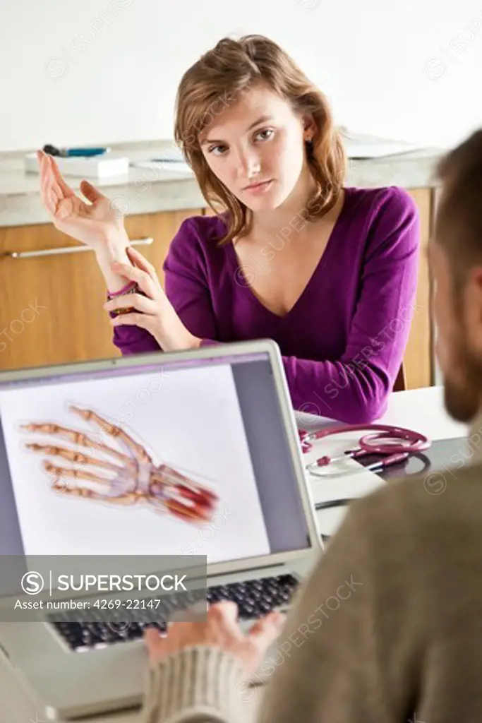 Woman consulting for wrist pain.