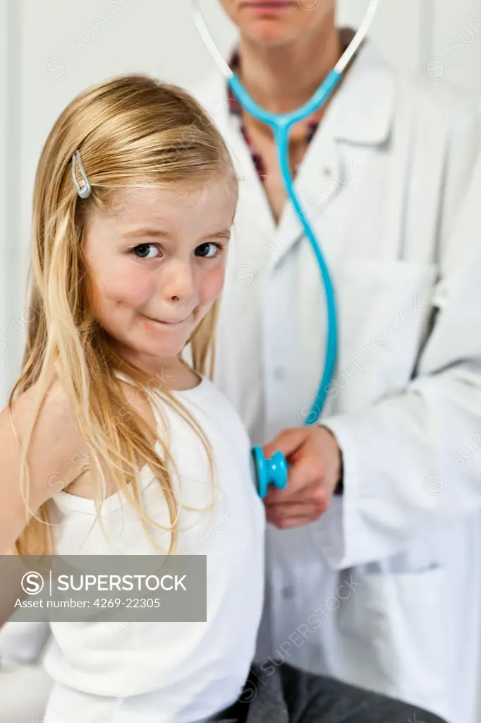 Doctor examining a 5 year old girl with a stethoscope.
