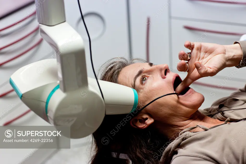 Dentist taking dental X-ray of a patient.