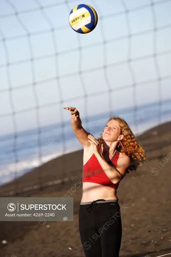 Woman playing beach volley.