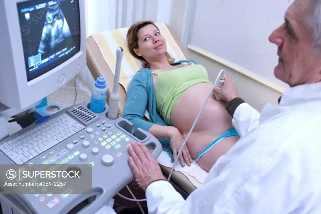 9 months pregnant woman undergoing an obstetrical ultrasound scan performed by a gynecologist.