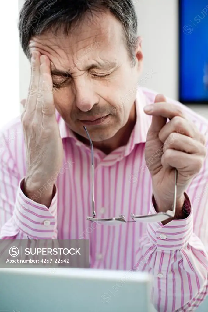 Man suffering from headache.