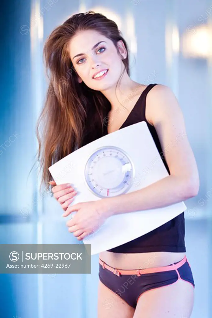 Woman holding scale.