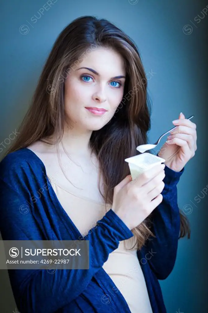 Woman eating yogurt.