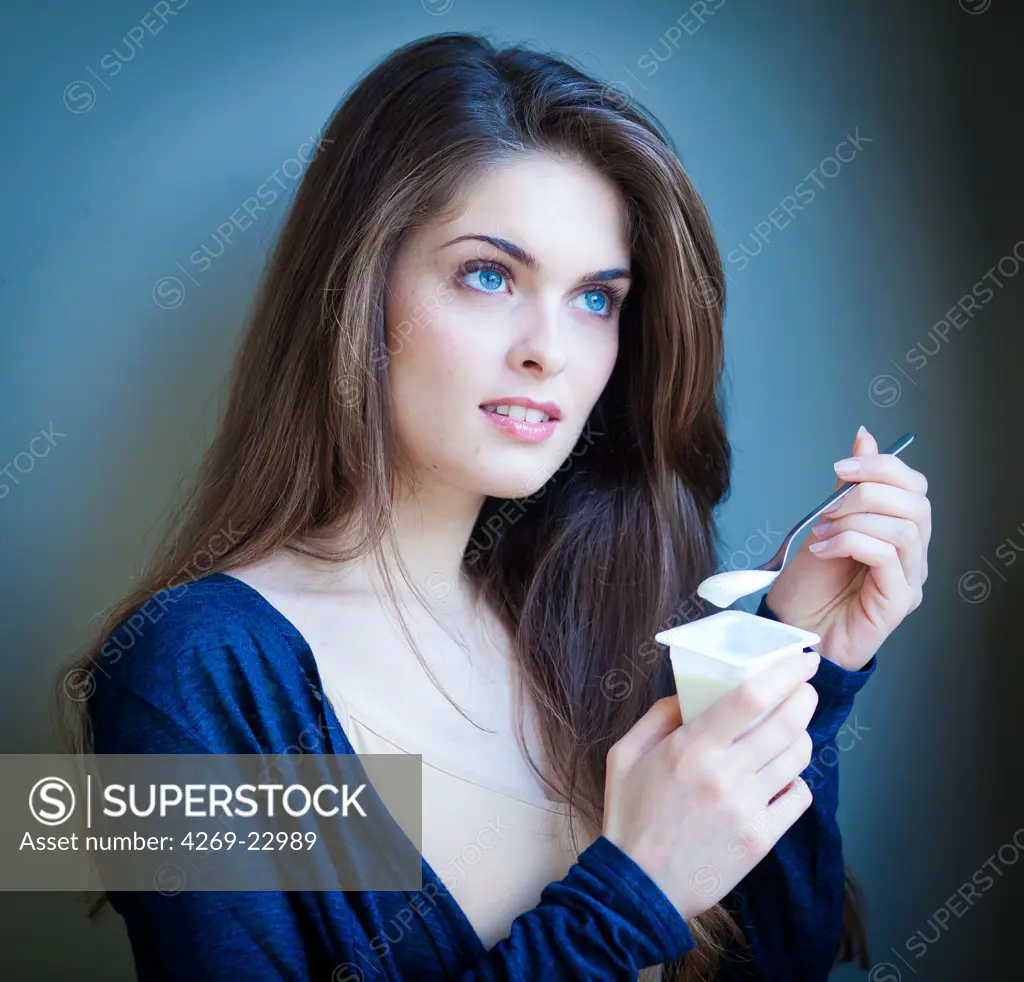 Woman eating yogurt.