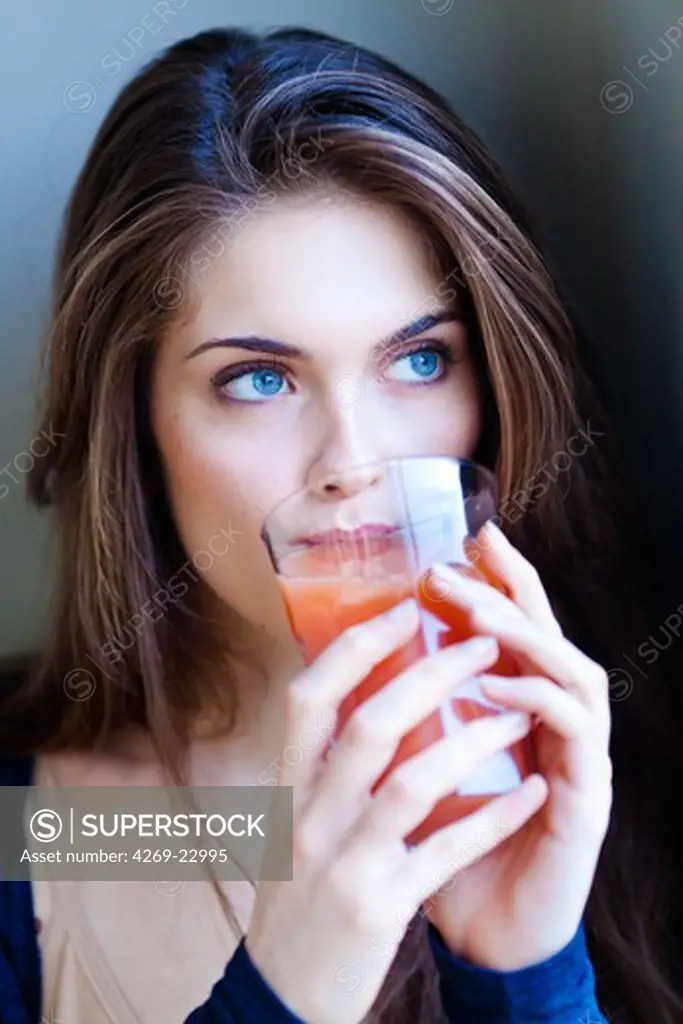 Woman drinking fruit juice.