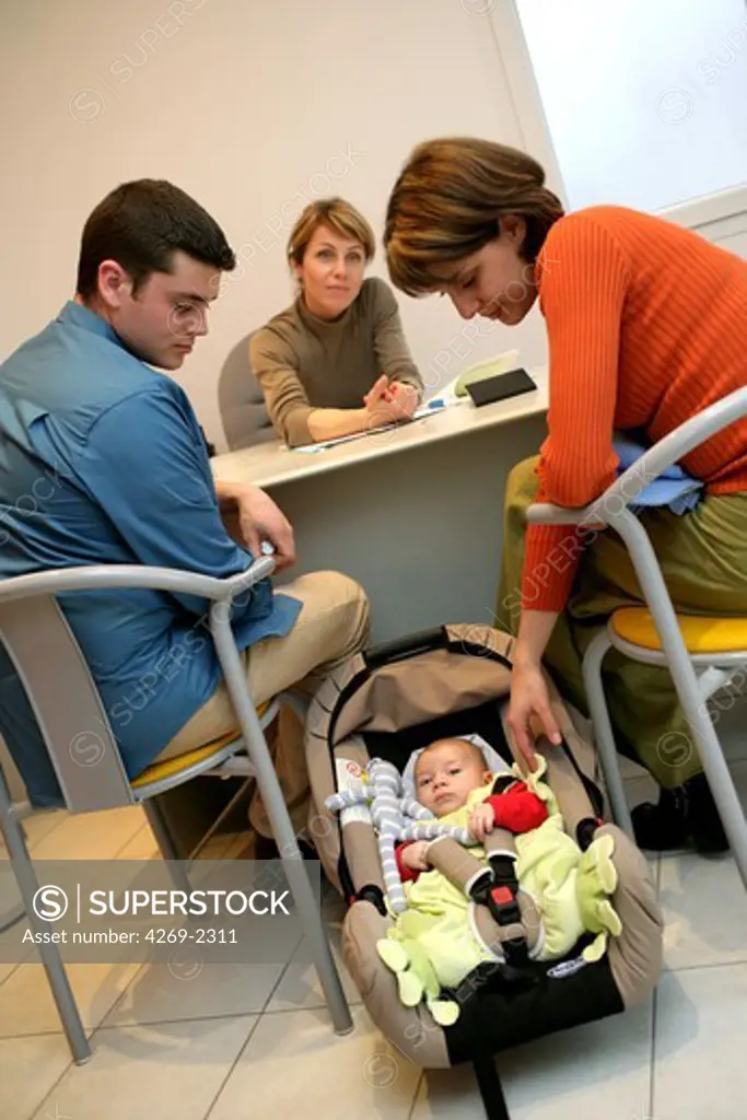 Couple with their 3 months old baby in consultation.