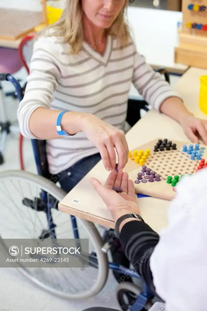 Functional rehabilitation of a hemiplegic woman. Occupational therapy session. Department of Physical Medicine and Rehabilitation, Limoges hospital, France.