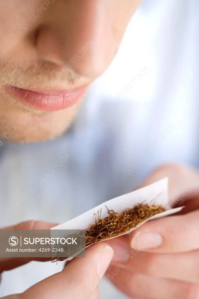 Man rolling himself a cigarette.