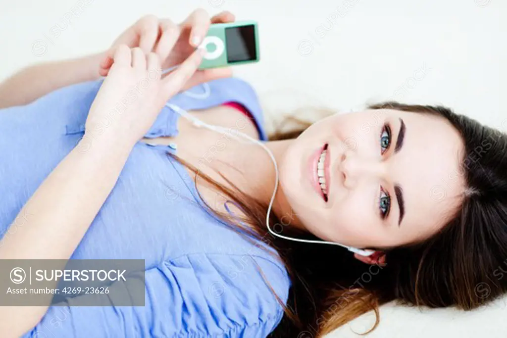 Woman listening to music on an ipod MP3 player.