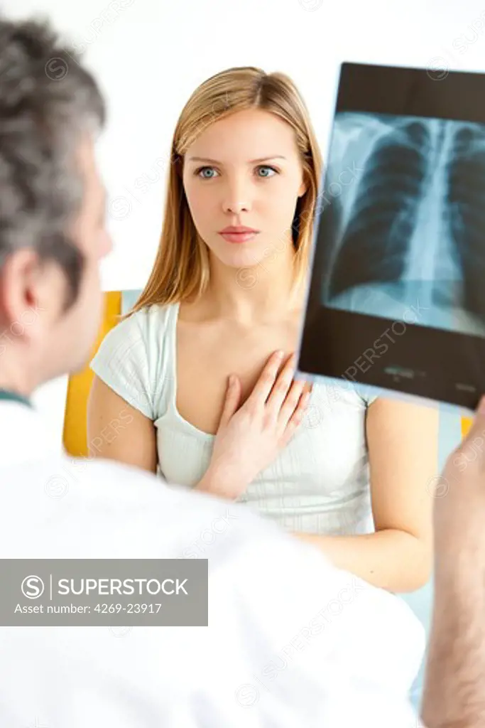 Doctor examining and commenting patient's lungs X-ray.