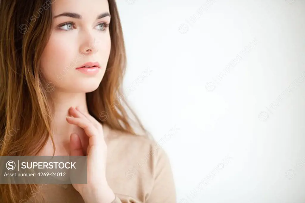 Woman self-examining her throat.