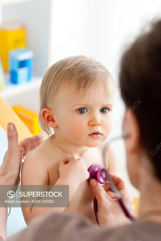 Doctor examining a 14 months old baby with a stethoscope.