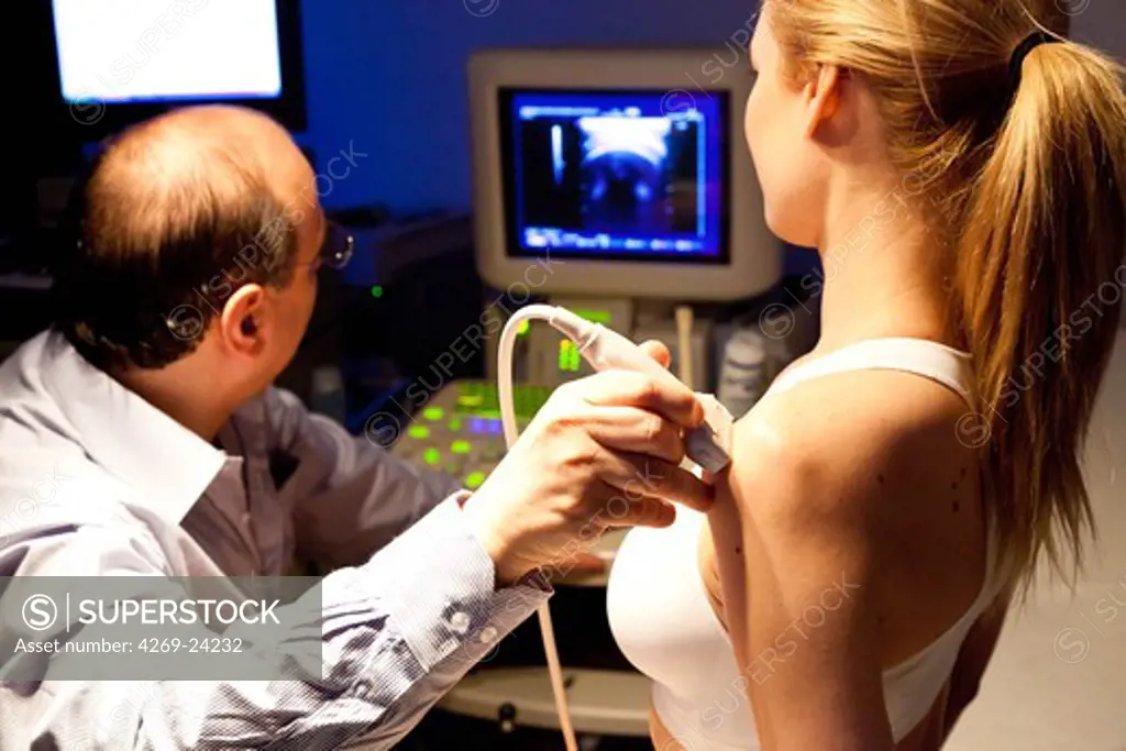 Woman undergoing shoulder ultrasound scan.