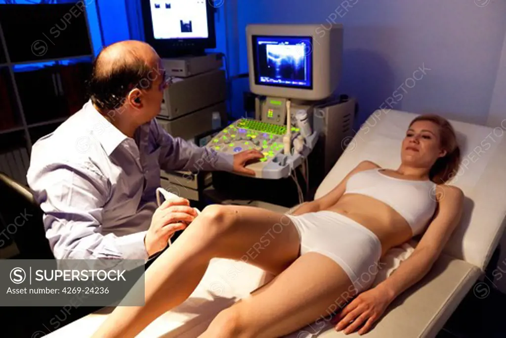 Woman undergoing knee ultrasound scan.