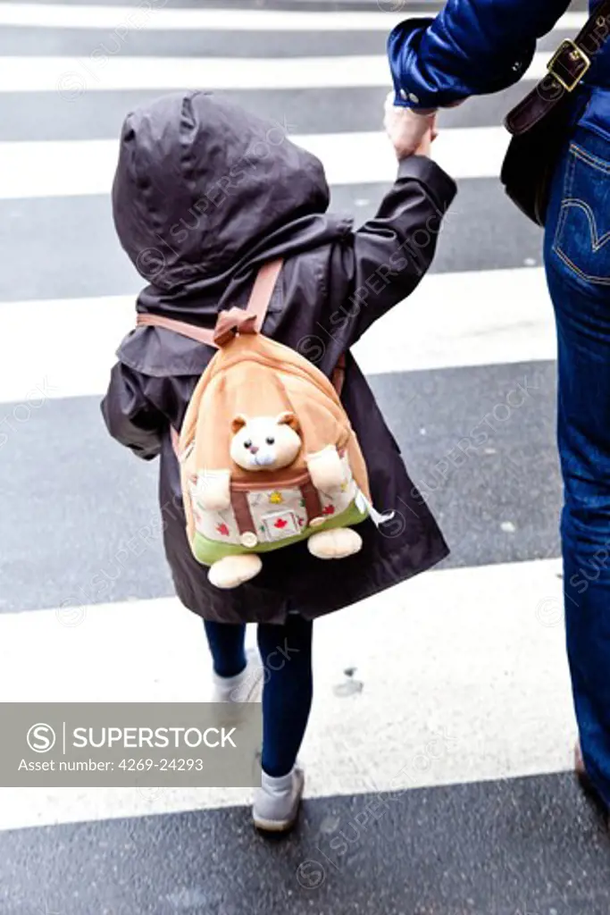 4 years old girl on her way to school.