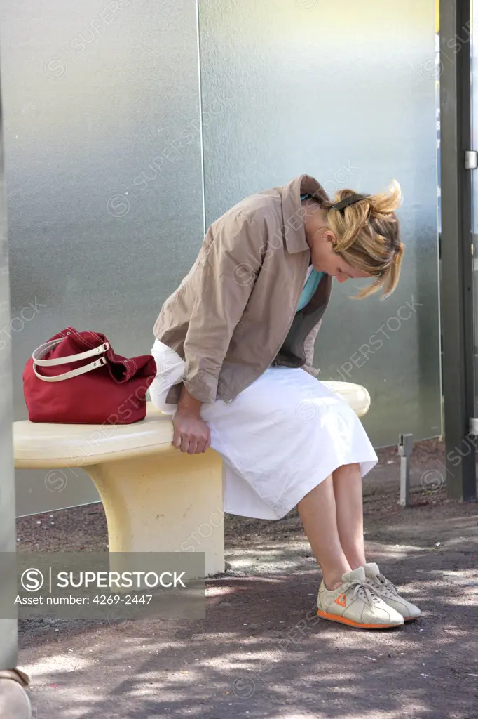 Woman experiencing about of dizziness or feeling faint.