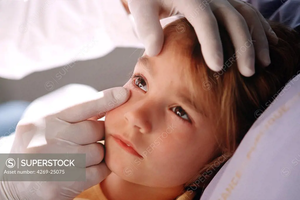 Medical consultation. Eye specialist examining the eye of 6 years of girl.
